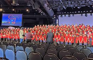 Students sing together at mass choir concert at Disney World.